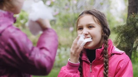 Two sisters eat cotton candy on a stick and laughing Stock Footage 84262805