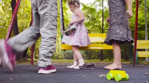 Two sisters get up from the swing and put on their shoes Video stock 95470643