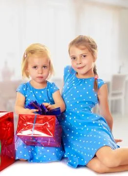Two sisters with a gift Stock Photos