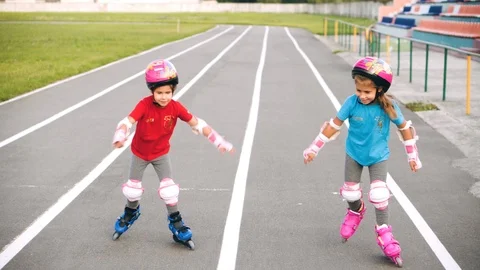 Two sisters go on roller skates at the stadium. Stock Footage 113268923