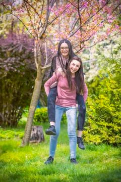 Two sisters having fun in the park Stock Photos