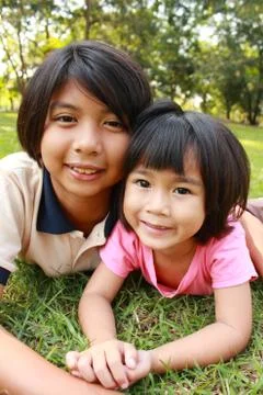 Two sisters having good time in the park. Stock Photos