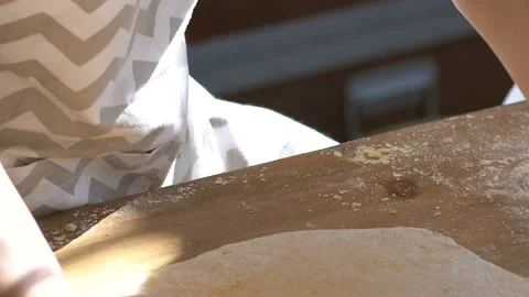 Two sisters kneading dough on the kitchen table with rollin pin. Video stock 106236358