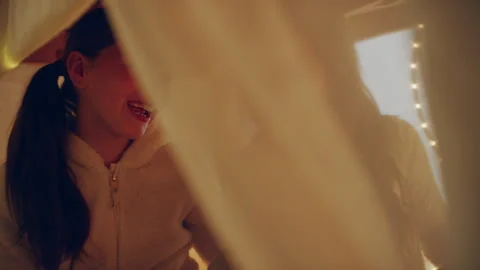 Two sisters playing under the blanket fort Stock Footage 279746017