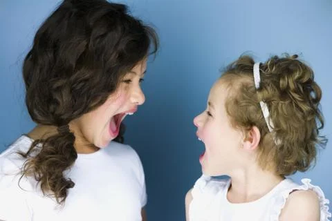 Two sisters posing and smiling Stock Photos