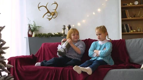 Two sisters quarrel and can't share a gift box with each other Stock Footage 194741828