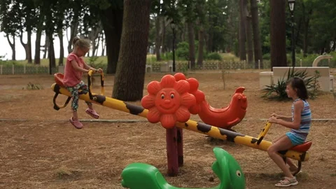 Two sisters ride a swing in a children's Park. Stock Footage 110925258