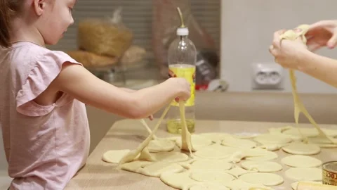 Two sisters roll out dough for cooking and baking homemade buns Stock Footage 167023862