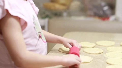 Two sisters roll out dough for cooking and baking homemade buns Stock Footage 167023970