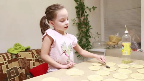 Two sisters roll out dough for cooking and baking homemade buns Stock Footage 167024181