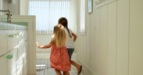 Two sisters running and playing in their house. 스톡 동영상 88369831