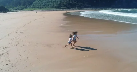 Two sisters running on the beach Stock Footage 80884511