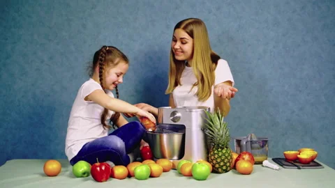 Two Sisters Sits in the Kitchen by the Table Video stock 136174545
