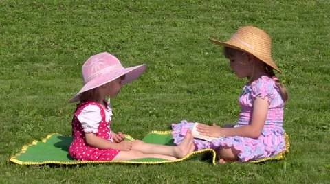 Two sisters sitting on the grass Stock Footage 54314863