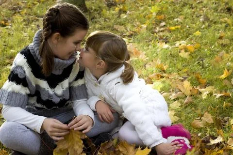Two sisters sitting in the park Stock Photos