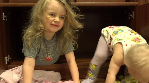 Two Sisters Sitting in Wardrobe, Crazy Fun. 4K UltraHD, UHD Vídeos de archivo 82678616