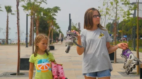 Two sisters standing with roller skates Stock Footage 126910491