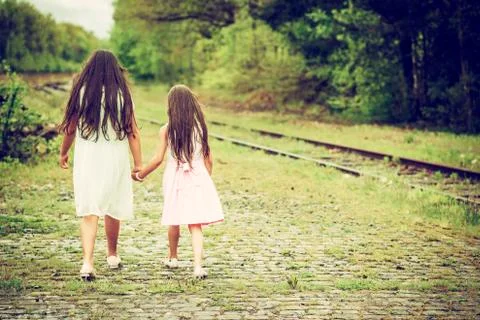 Two sisters walking away from the camera Stock Photos