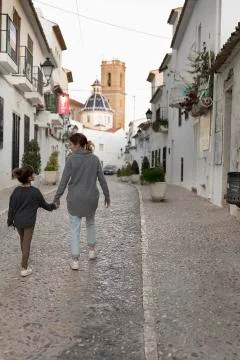 Two Sisters walking hand in hand through the town of Altea. Stock Photos