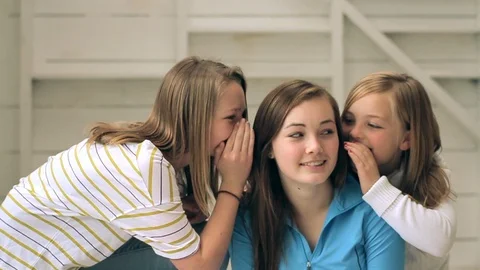 Two sisters whispering into the ear of their older sister. Vídeo Stock 88438302