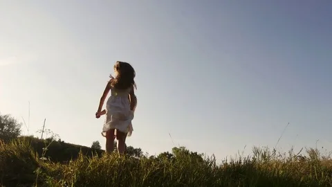 Two sisters in white dresses in the garden at sunset. The girls hug and laugh Stock-Footage 80348542