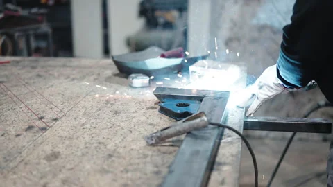 Two size cut metal bars on working table surface in workshop, blacksmith in Stock-Footage 262572422