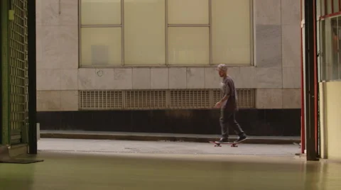 Two skateboarders performing skating tricks in alley Stock Footage 61273203