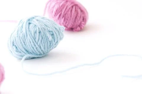 Two skeins of multi-colored yarn on a light background Stock Photos