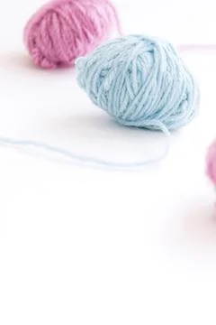 Two skeins of multi-colored yarn on a light background Stock Photos
