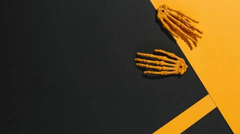 Two skeleton hands orange paper. High quality and resolution beautiful photo Stock Photos