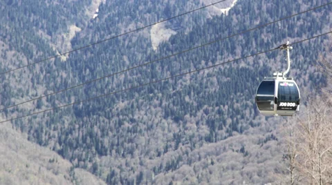 Two Ski Lifts is Moving Mountains in the Background, Sunny Weather, Spring, Stock Footage 63573408