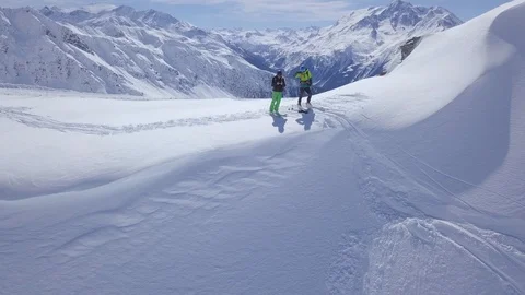 Two skiers admire the panorama, La Rosiere, Espace San Bernardo, France Stock Footage
