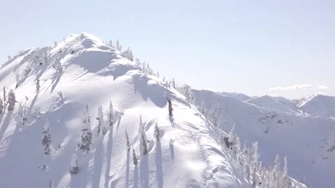 Two skiers approaching the summit of a mountain. Stock Footage 150135210