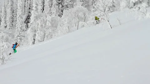 Two skiers bootpack up a hill to hit a jump Stock Footage 36316502