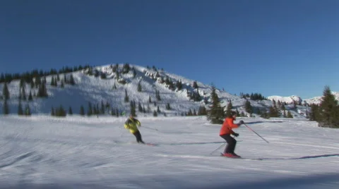 Two skiers on flat slope part II Stock Footage 92450