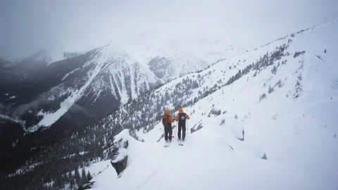 Two skiers standing on the snow covered mountain Stock Footage 116631460