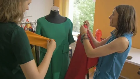 Two skilled designers making a new dress for fashion collection. Stock Footage 80471349