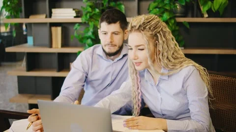 Two skilled professionals are productively engaged in a collaborative project Stock Footage 285680635