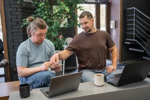 Two skilled professionals devops engaged in collaborative efforts within a Stock Photos