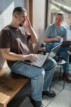 Two skilled professionals devops engaged in collaborative efforts within a Stock Photos