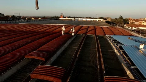 Two skilled workers remove the sheets of asbestos cement on a roof. Stock-Footage 71841576