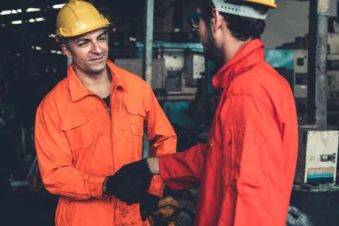 Two skillful factory engineer or worker showing teamwork and partnership . Stock Photos