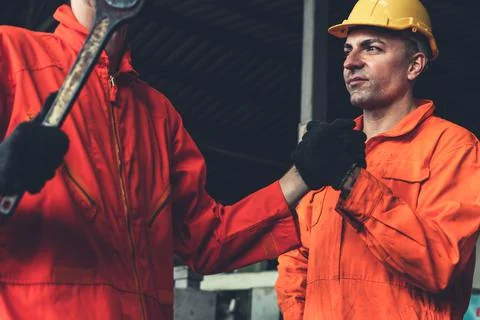 Two skillful factory engineer or worker showing teamwork and partnership . Stock Photos