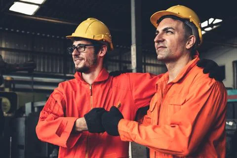 Two skillful factory engineer or worker showing teamwork and partnership . Stock Photos