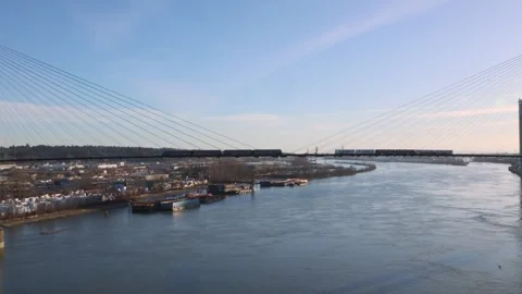 Two sky trains cross the Sky Bridge across the fraser river Stock Footage 269617953