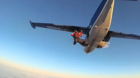 Two skydivers. Jumping out. Stockbeeldmateriaal 86507742