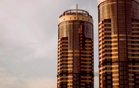 Two skyscraper building sunset background sky clouds Stock Photos