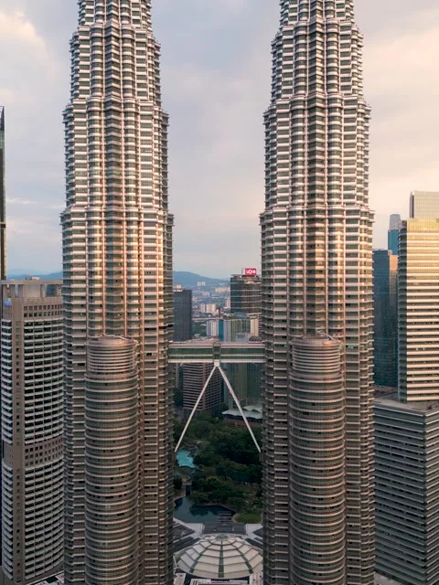 Two skyscrapers Petronas towering next to each other in the urban cityscape Stock Footage 269304339