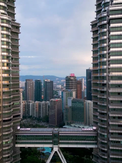 Two skyscrapers Petronas towering next to each other in the urban cityscape Stock Footage 270480653