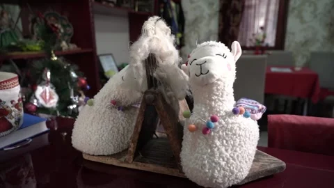 Two sleeping Lamb dolls on the table Stock Footage 197104206